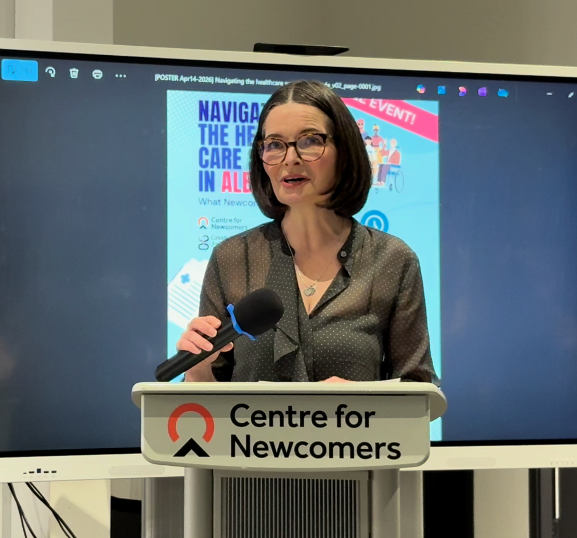 Doreen Rabi at the podium at the Centre for Newcomers