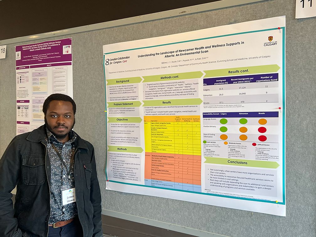 James Idowu standing in front of his poster as presented at CAHSPR 2026